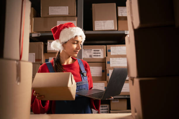 istock Employee checking stock and inventory with laptop computer in retail warehouse. Working in logistics, distribution center. 1730979999