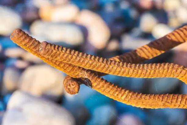 Photo of Beautiful natural installation of metal rods on the background of stones