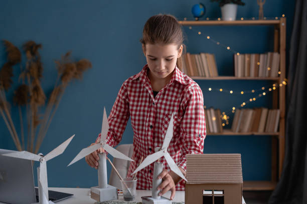 teen girl making ecology project related to the alternative sources of energy at home. - child prodigy imagens e fotografias de stock