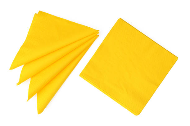 Yellow paper napkins on white background studio shot