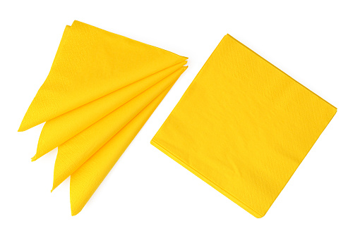 Yellow paper napkins on white background studio shot close up