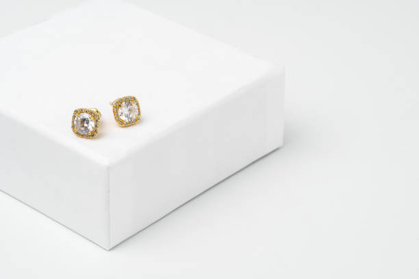 istock Golden earrings on display on white background 1730982653
