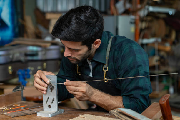istock Guitar Luthier Bends Fretwire 1730984294