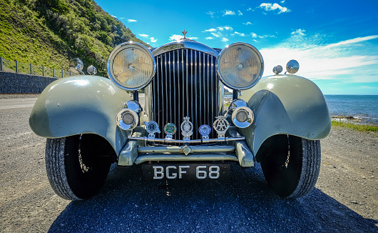 Christchurch, New Zealand - Nov 5, 2016. A vintage car on seaside road at sunny day in Christchurch, New Zealand.