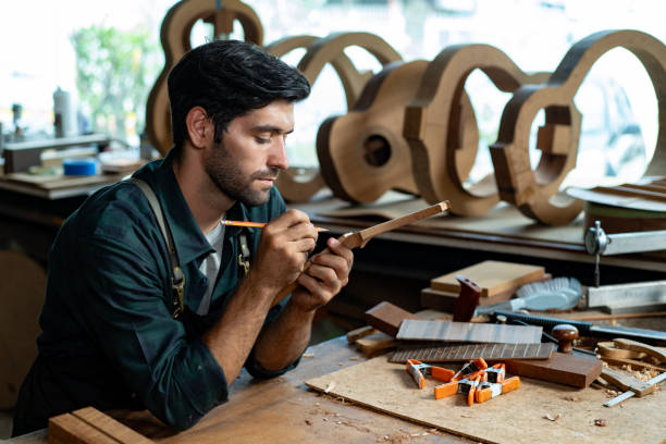 istock Acoustic Guitar Luthier Inspecting Guitar Neck Bend or Straight 1730987717