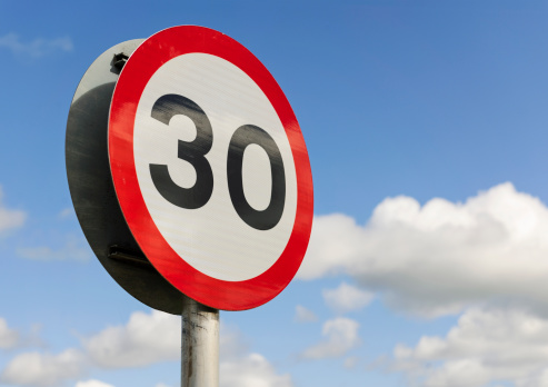 A British road sign for a 30 mile per hour speed limit area.