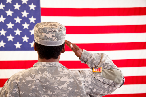 Female in military uniform saluting American flag.  MORE LIKE THIS... in lightboxes below.