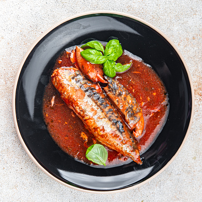 mackerel in tomato sauce and basil fresh canned fish delicious seafood healthy eating cooking appetizer meal food snack on the table copy space food background rustic top view
