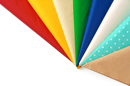Colorful stack of paper napkins on white background studio shot