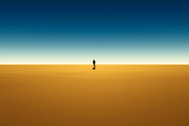 A man in an office suit stands in the center of a large desert.