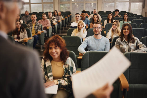 istock Happy college students attending a lecture in amphitheater. 1731054512