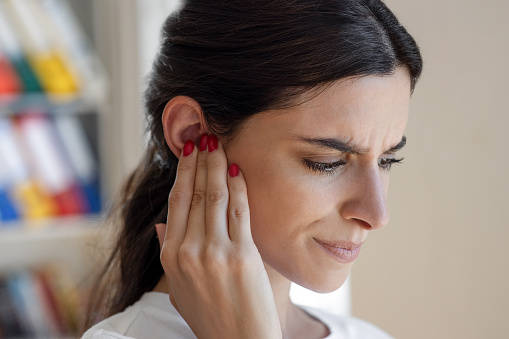 Woman have tinnitus,noise whistling in her ears