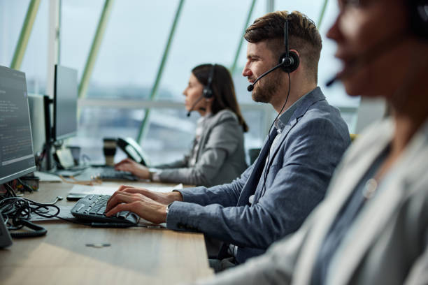 istock Happy male customer service representative working on PC in a call center. 1731070195