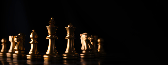 Golden chess team include King Queen horse ship and pawn on dark background for business strategy and sport tactic by team building concept.