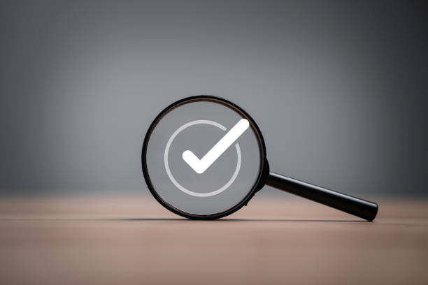 istock White correct sign symbol inside black magnifier glass for document and project approve , ISO quality assurance control concept. 1731101236