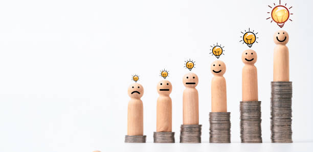 istock Wooden figure of human standing on increasing coins stack with glowing lightbulb for creative thinking , problem solving and solution can make more money concept. 1731101766