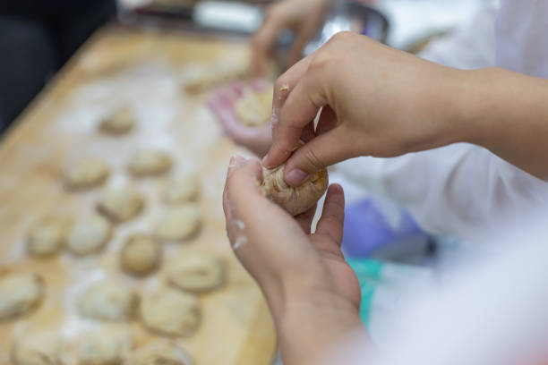 istock Chinese pasta making: woman kneading dough. Dough for steamed buns. 1731106531