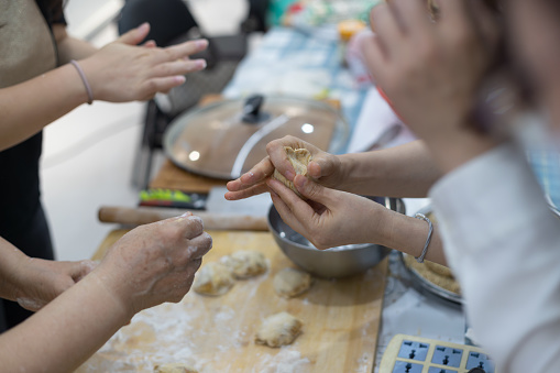 Chinese pasta making: woman kneading dough. Dough for steamed buns.