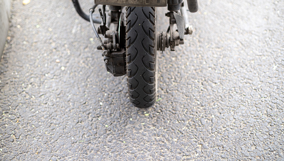Single black tire of motorcycle, isolated on white background.