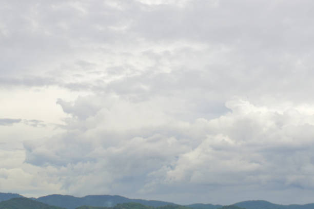 istock Clouds in the sky with hill foreground 1731113585
