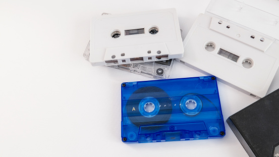 Cassette tapes stacked on top of each other on a white background. 1990s.3