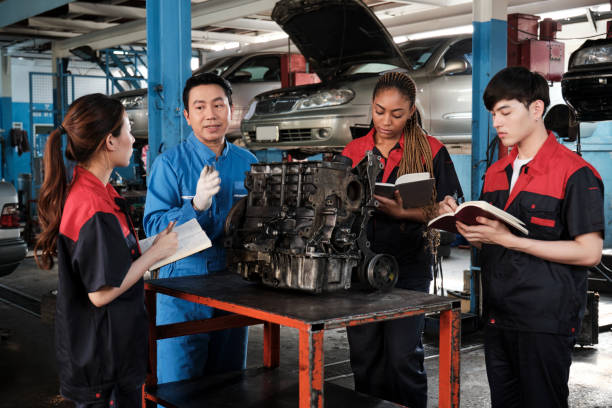 istock Supervisor engineer is teaching mechanic workers about car engines at a garage. 1731134337