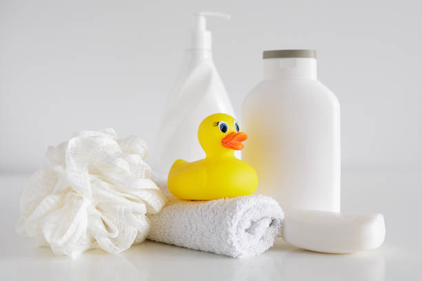 istock Bath concept - Sponge, douch gel, soap, towel and duck on white table 1731139324