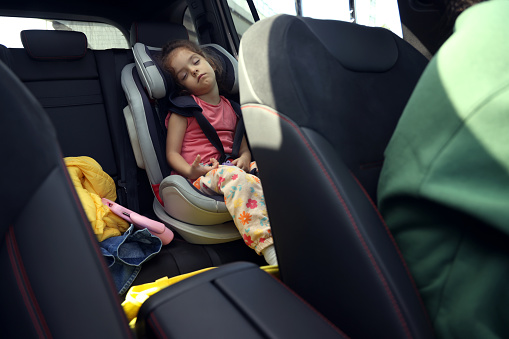 Little girl sleeping car safety seat