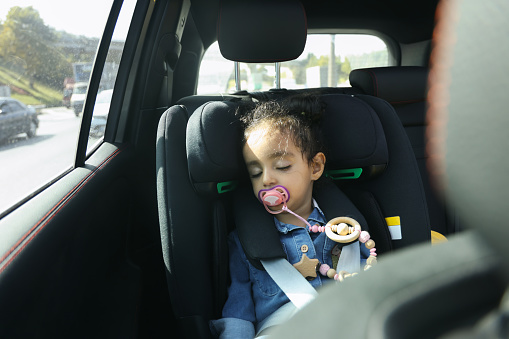 istock Little girl sleeping car safety seat 1731149314