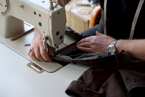 Tailor at work on sewing machine