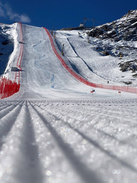 Low angle view of ski racing slope at Soelden glacier, Austria in autumn Low angle view of ski racing slope at Soelden Rettenbachferner glacier, Austria in autumn against blue sky rettenbach glacier stock pictures, royalty-free photos & images