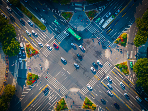 Aerial View of Cars Driving Through Intersection