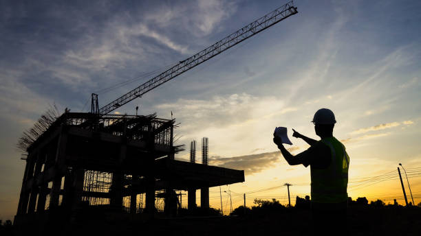 istock Silhouette of Engineer and excavator workingon building site, construction site at sunset in evening time. 1731167702