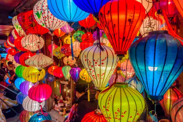 Colourful cloth lanterns lamp light shades hanging outside in Hoi An, Vietnam