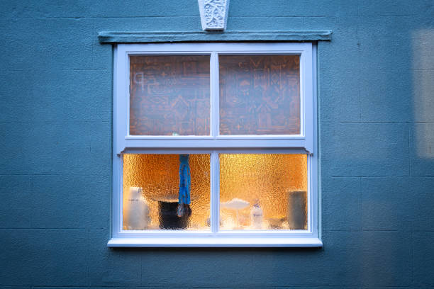 istock Abstract view of a frosted glass kitchen window showing cleaning objects on the inside ledge. 1731170551