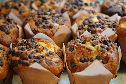 Closeup image of chocolate muffins on display.