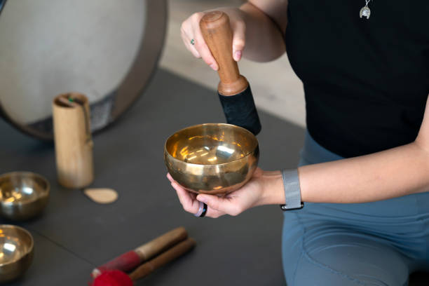 istock A girl plays Tibetan singing bowls. 1731218260