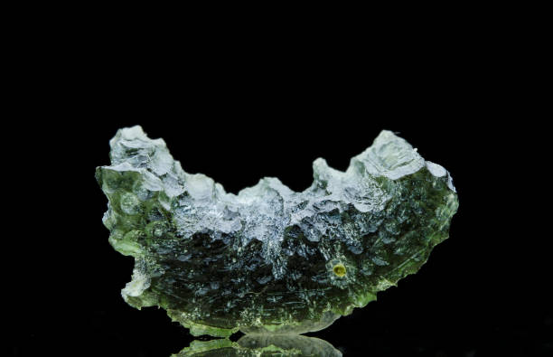istock Moldavite stone isolated on a black background. 1731236971