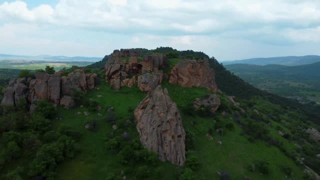 Aerial view of lush forest and ancient rocks in the mountains