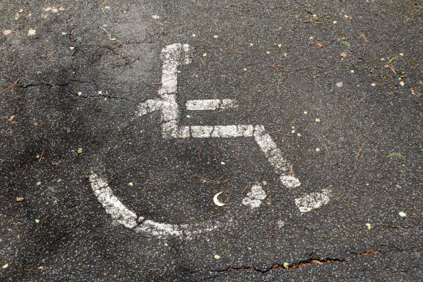 istock wheelchair sign on asphalt path 1731257397