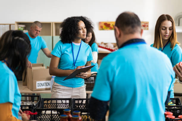 istock Charity workers helping vulnerable victims with food donations 1731259556