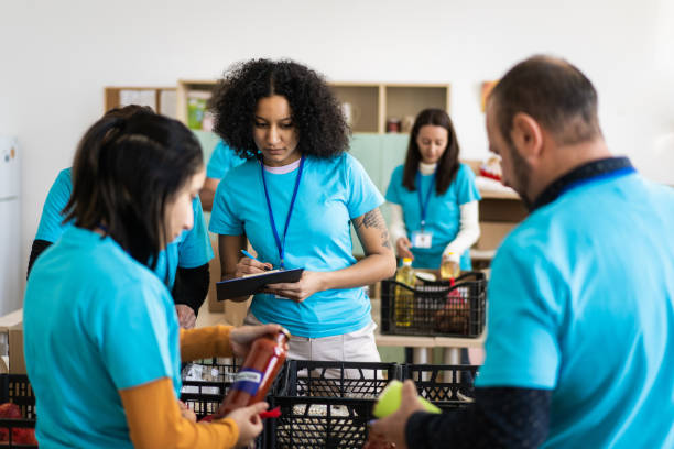 istock Community volunteers sorting food donations into crates 1731259695
