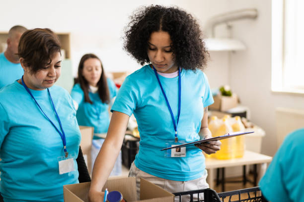istock Female charity workers sorting grocery donations 1731259697