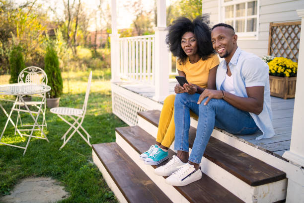 istock A smiling couple sitting together on the front yard steps 1731260276