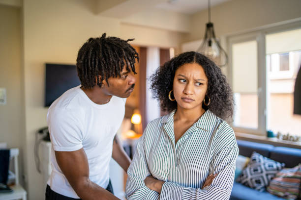 istock A disappointed woman looking sad while her worried husband is looking at her 1731262038