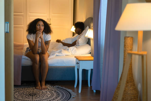 istock A wistful woman sitting on bed edge 1731262056