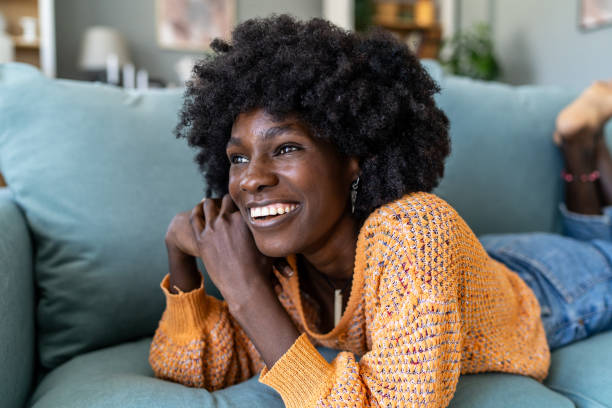 istock An Afro-American woman lying on a couch 1731262101