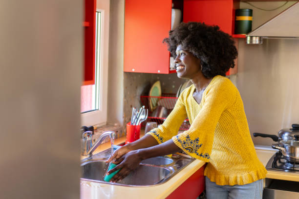 istock Woman washing in kitchen 1731262676