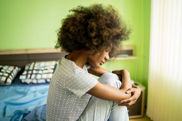 istock Lonely woman sitting on the bed 1731263817