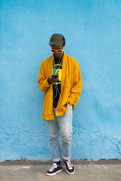 istock Fashionable guy looking at his phone 1731264406